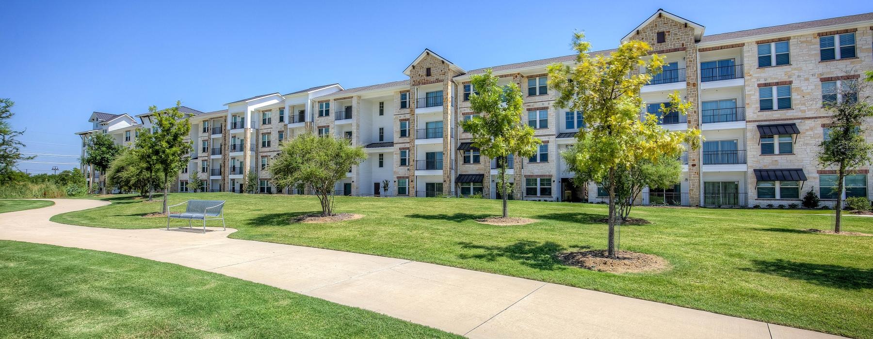 a building with trees and grass