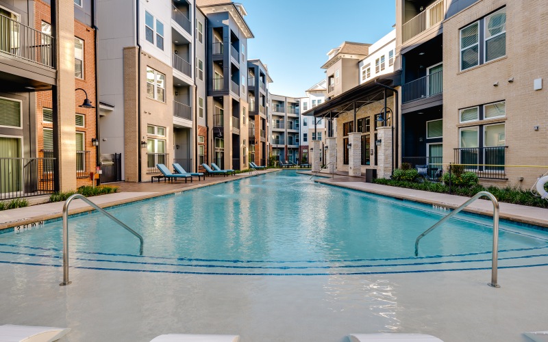 Wide angle of a pool enclosed in a courtyard